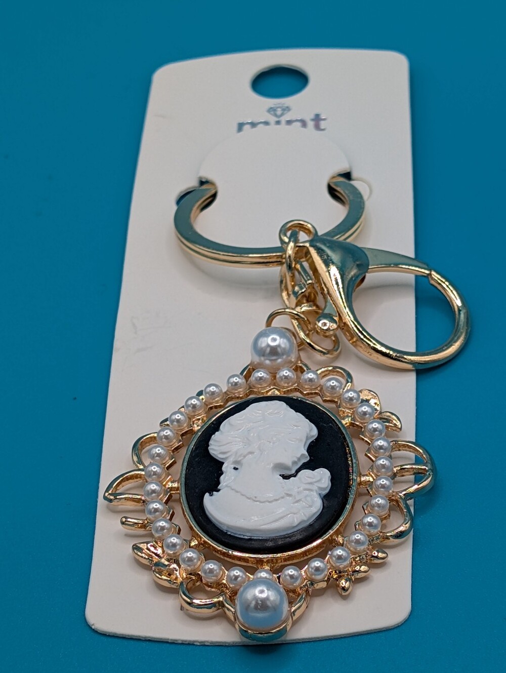 Mint gold-tone cameo brooch Bagcharm/ keychain with white and black accents